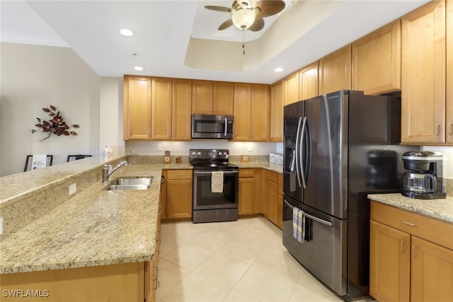 kitchen featuring ceiling fan, appliances with stainless steel finishes, light stone countertops, and sink