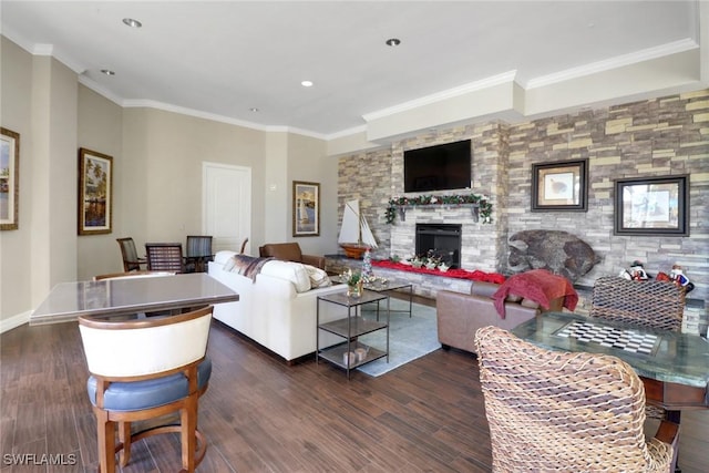 living room featuring crown molding, dark wood-type flooring, and a fireplace