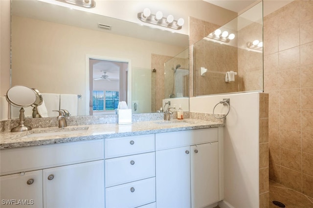 full bathroom featuring double vanity, walk in shower, a sink, and visible vents