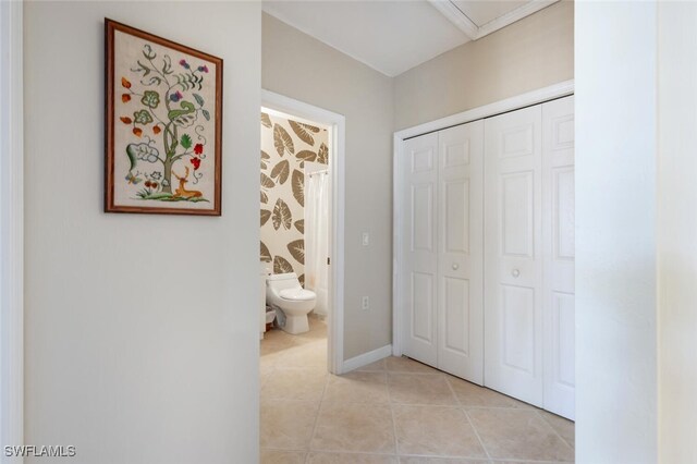 hall featuring light tile patterned floors