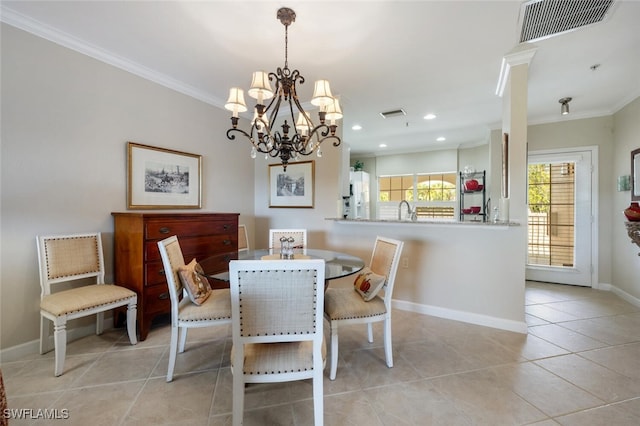 dining space with crown molding, sink, light tile patterned floors, and a notable chandelier