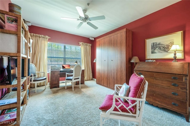 carpeted office featuring a ceiling fan