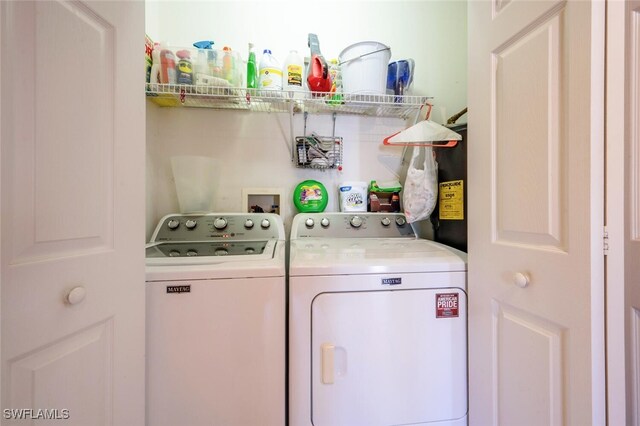 washroom with washing machine and clothes dryer