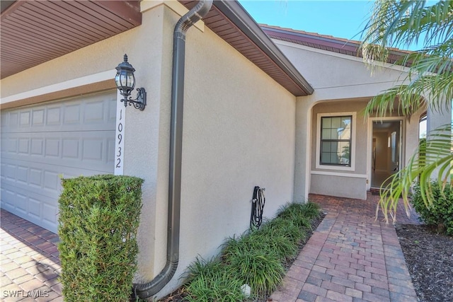 view of exterior entry with a garage