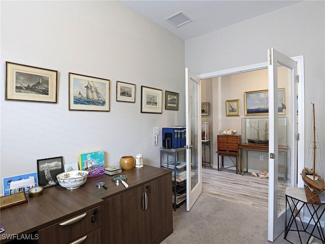 carpeted office featuring french doors