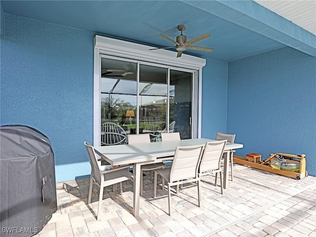 view of patio featuring ceiling fan and a grill