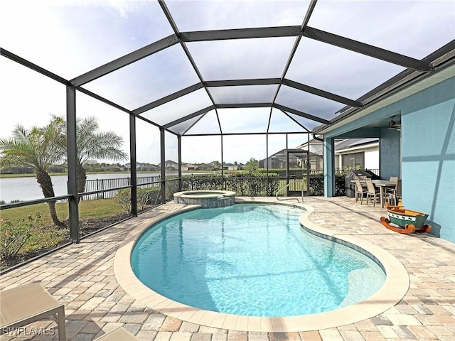 view of pool featuring an in ground hot tub, a water view, a lanai, and a patio area