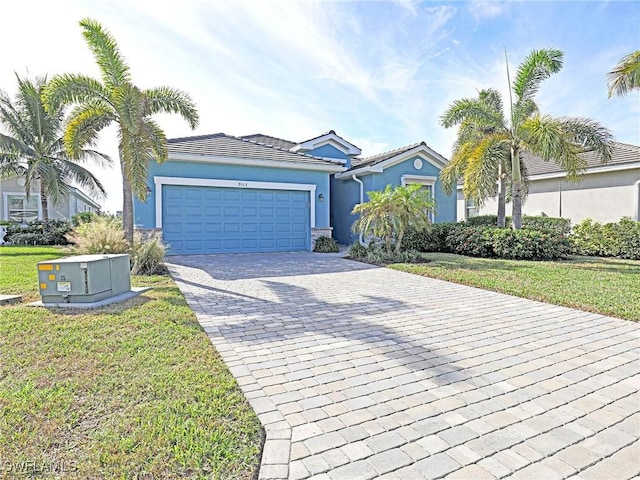 view of front of home featuring a garage and a front lawn