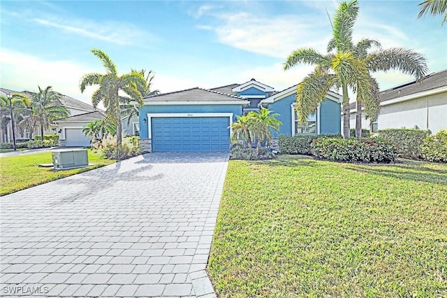 view of front of home with stucco siding, an attached garage, decorative driveway, and a front yard