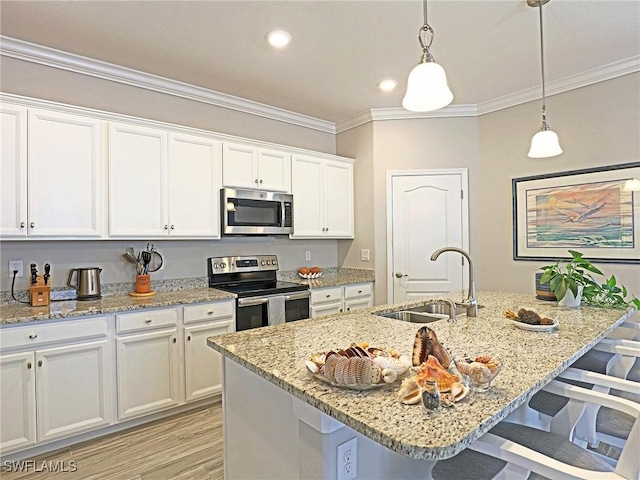 kitchen featuring sink, white cabinetry, stainless steel appliances, and a kitchen island with sink