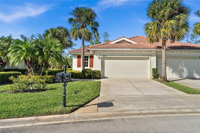 mediterranean / spanish home featuring a garage and a front lawn