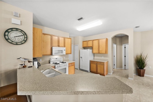 kitchen featuring kitchen peninsula, light brown cabinetry, white appliances, sink, and light tile patterned flooring