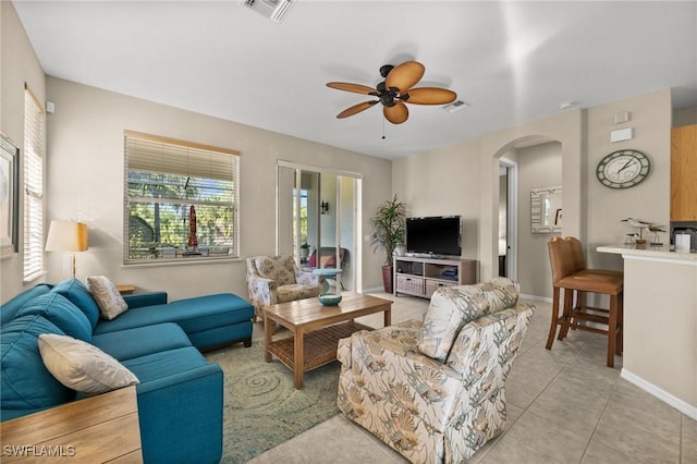 tiled living room featuring ceiling fan