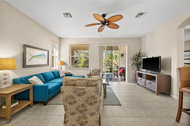 tiled living room with ceiling fan