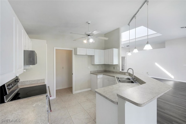 kitchen with decorative light fixtures, white cabinetry, sink, kitchen peninsula, and stainless steel electric range