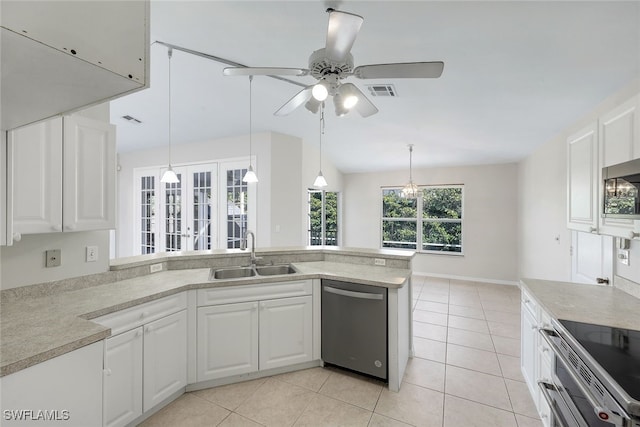 kitchen featuring pendant lighting, sink, appliances with stainless steel finishes, white cabinets, and light tile patterned flooring