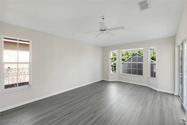 empty room featuring ceiling fan and dark wood-type flooring