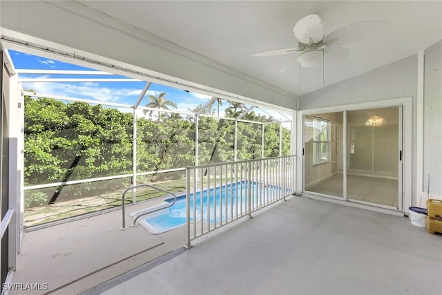 view of swimming pool featuring ceiling fan, a lanai, and a patio