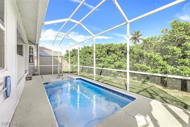 view of pool featuring a patio area, a lanai, and a storage shed