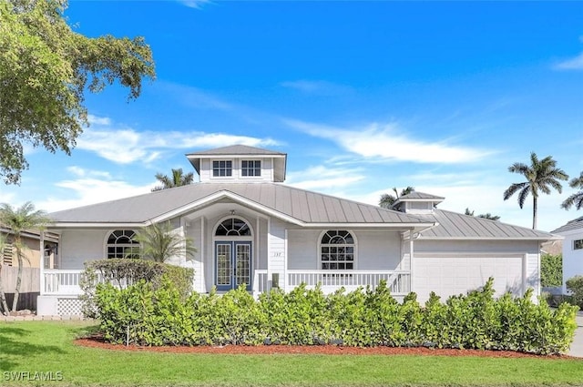 view of front of home with a garage and a front yard