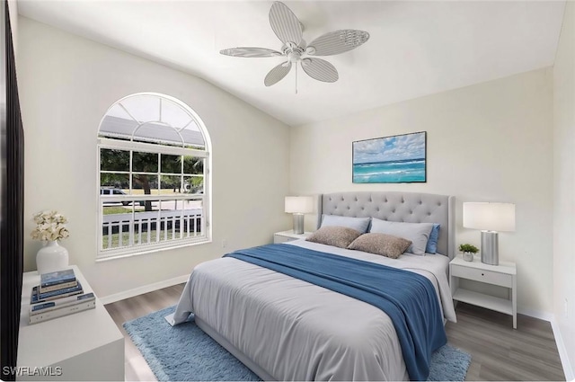 bedroom featuring ceiling fan, dark hardwood / wood-style floors, and lofted ceiling