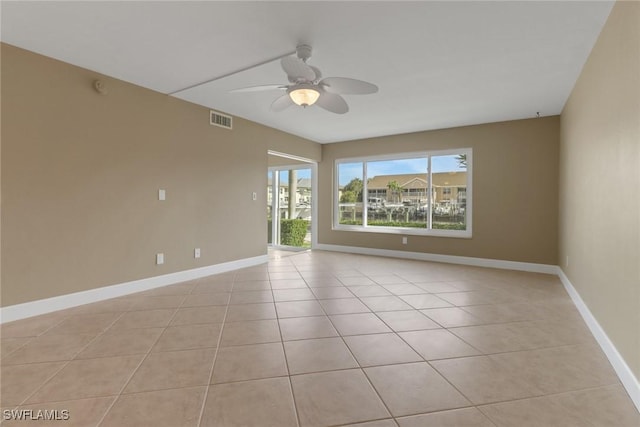 tiled empty room with ceiling fan