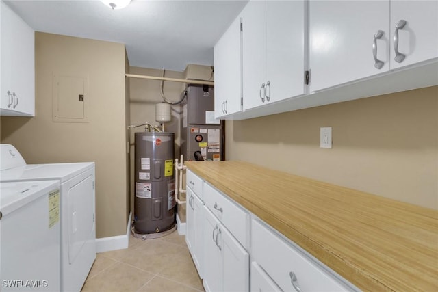 clothes washing area featuring cabinets, washing machine and dryer, electric water heater, electric panel, and light tile patterned floors