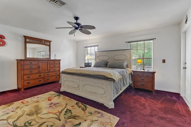 bedroom with dark colored carpet and ceiling fan