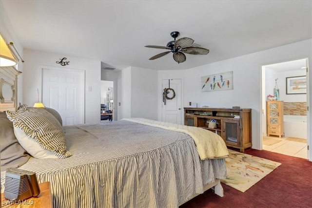 carpeted bedroom featuring connected bathroom, a closet, and ceiling fan