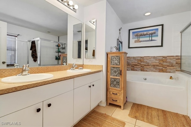 bathroom featuring tile patterned flooring, vanity, and shower with separate bathtub