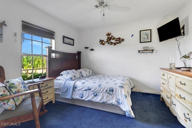 bedroom featuring ceiling fan and dark colored carpet