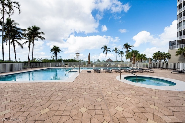 view of pool featuring a community hot tub and a patio