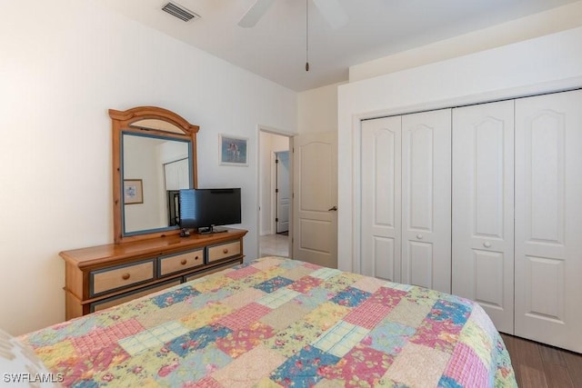 bedroom with hardwood / wood-style floors, a closet, and ceiling fan