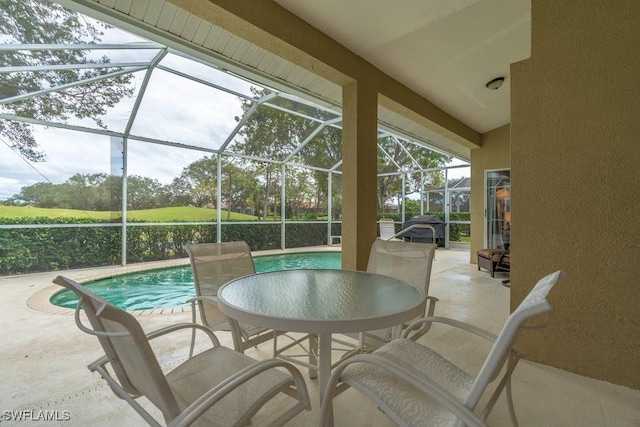 view of patio featuring a lanai