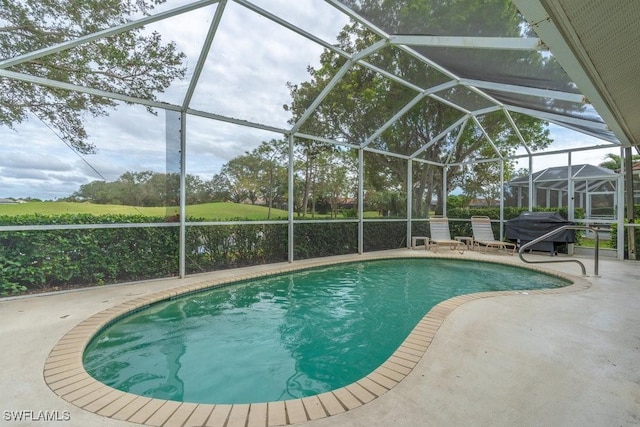 view of swimming pool featuring a lanai, area for grilling, and a patio