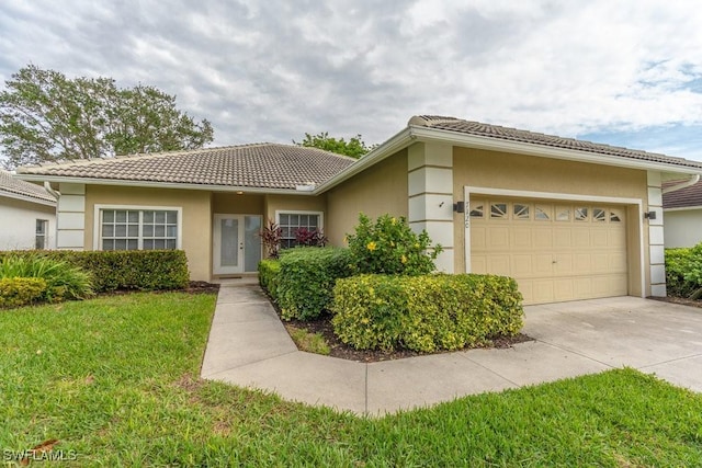 view of front of home featuring a garage and a front yard