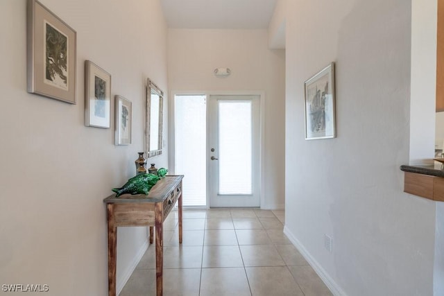 doorway featuring light tile patterned floors and french doors