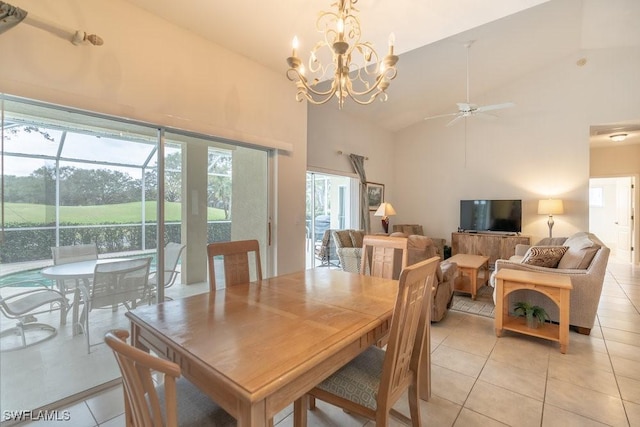 tiled dining room with high vaulted ceiling and ceiling fan with notable chandelier