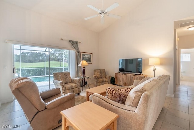 living room with light tile patterned flooring, a wealth of natural light, and ceiling fan