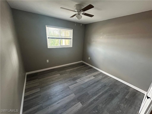 empty room featuring dark hardwood / wood-style floors and ceiling fan