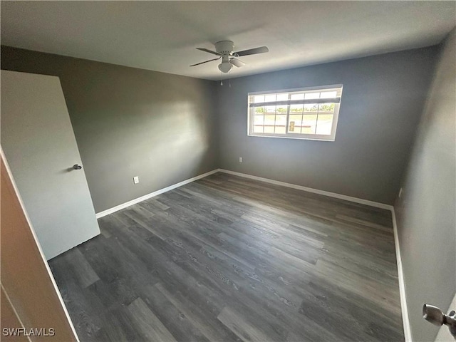 empty room featuring ceiling fan and dark wood-type flooring