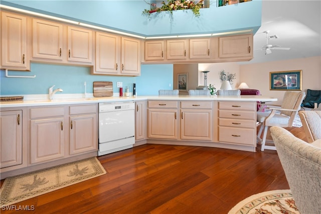 kitchen with dishwasher, kitchen peninsula, sink, and dark wood-type flooring