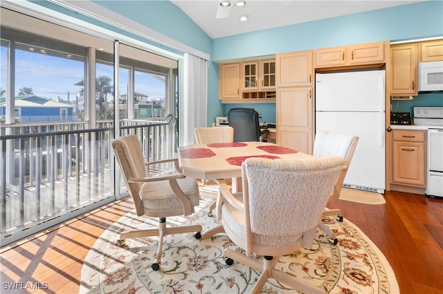 dining area featuring ceiling fan, dark hardwood / wood-style flooring, and lofted ceiling