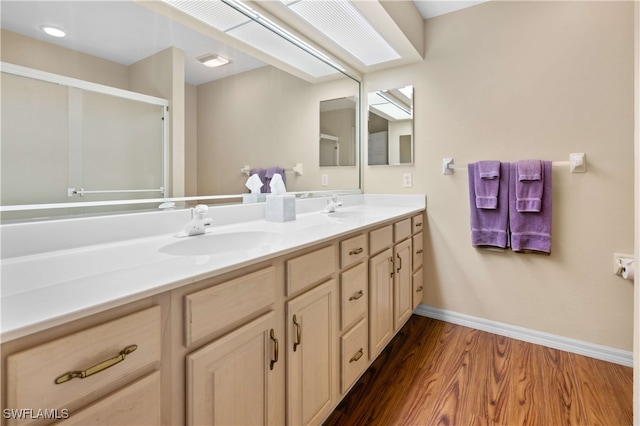 bathroom with hardwood / wood-style floors and vanity