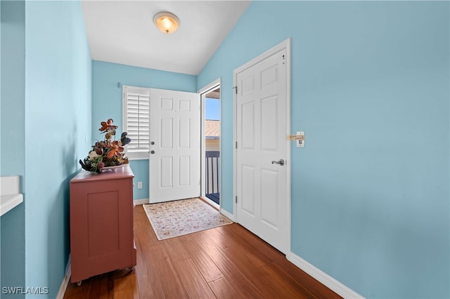 entryway featuring hardwood / wood-style floors and lofted ceiling