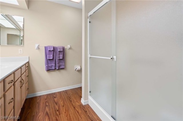 bathroom with vanity, hardwood / wood-style flooring, and an enclosed shower