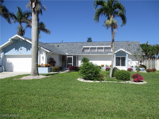 single story home featuring a front yard and a garage