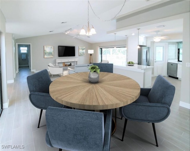 dining room featuring a chandelier and vaulted ceiling