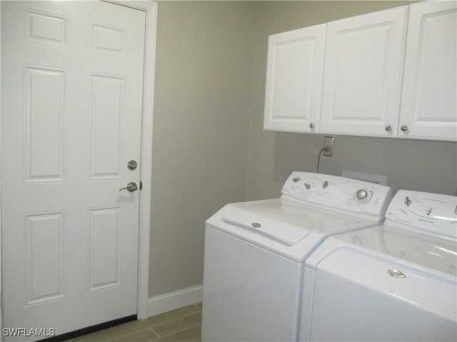 laundry area with cabinets and washer and clothes dryer