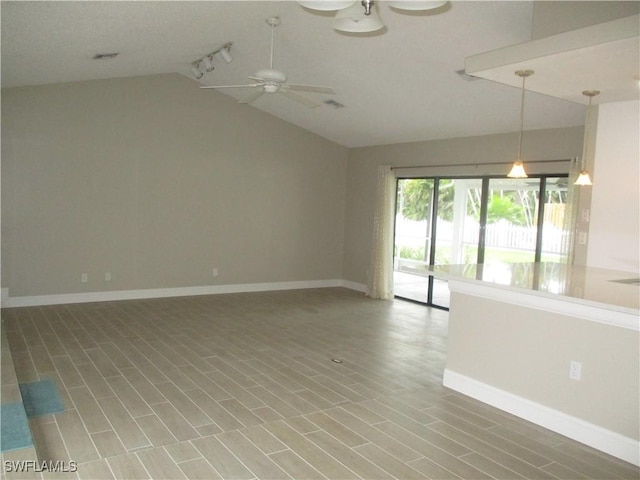 unfurnished room featuring ceiling fan and vaulted ceiling